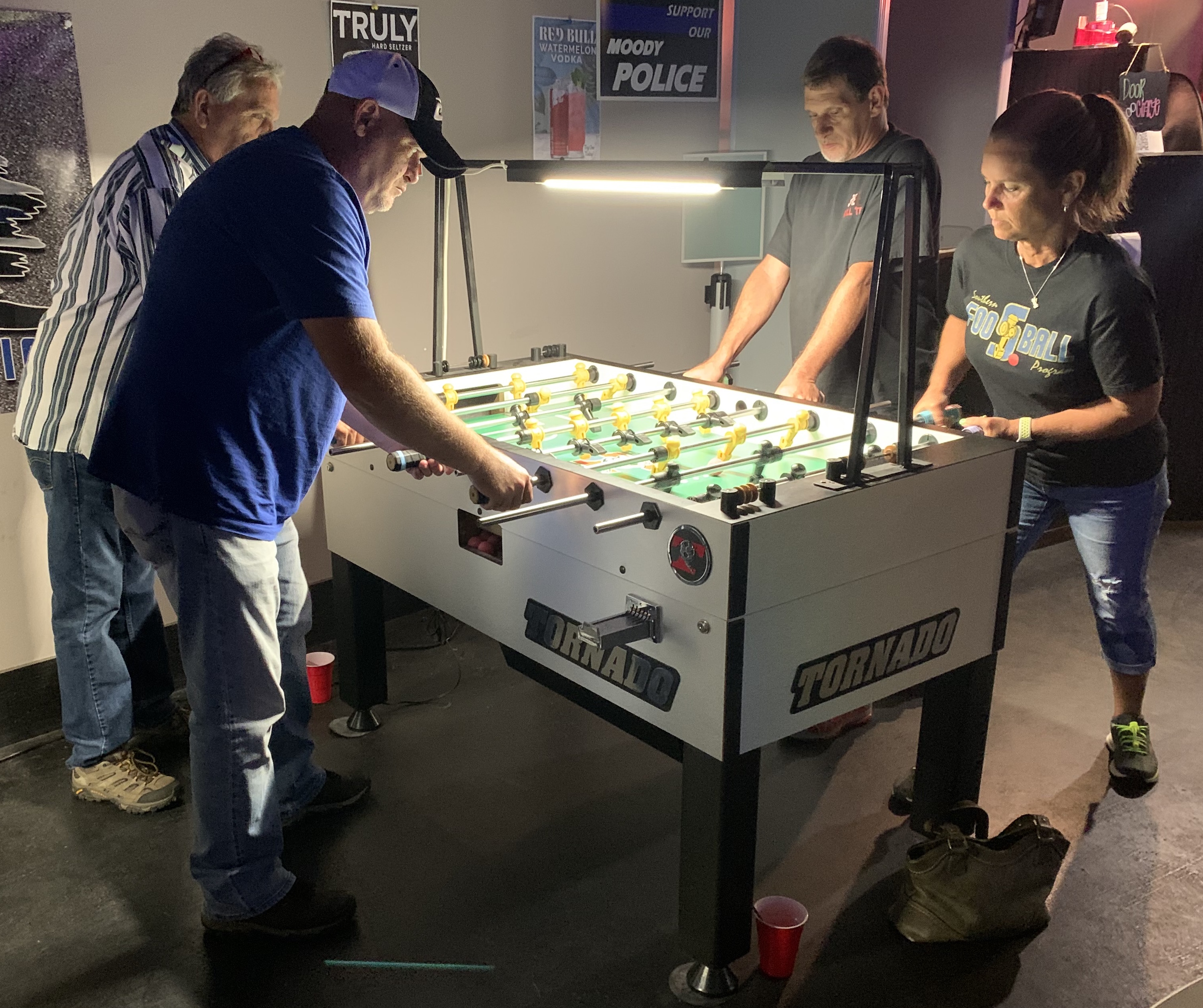 Open BYP foosball action at Van's Bar in Leeds,AL. with the event champs Steve Dodgen & Ken Williams shown on the left competing in a match vs Randy Strickland & Cheryl Lowe of which had already taken down the top seeded team of the tournament.